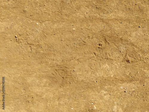Fotografía Dry sandy soil texture field overhead background