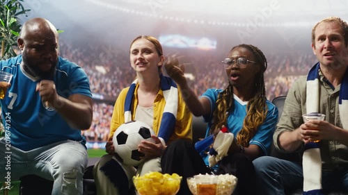 Passionate soccer fans celebrate goal and enjoy stadium experience while watching match at home as thrilled football supporters react to favorite team win and stadium crowd energy.