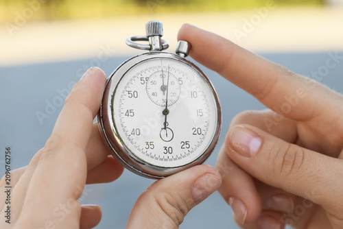 Person holding a silver sto...
