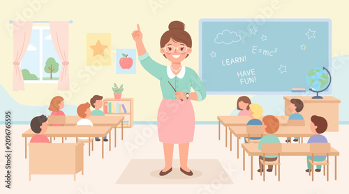 A teacher standing in a classroom with students.