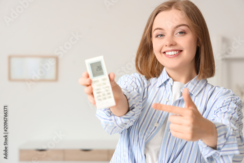 Smiling young woman holding...