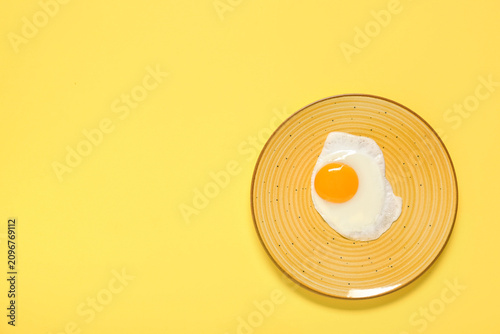 Plate with tasty fried egg ...