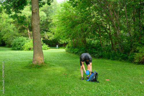 Disc Golfer Selecting Next Disc