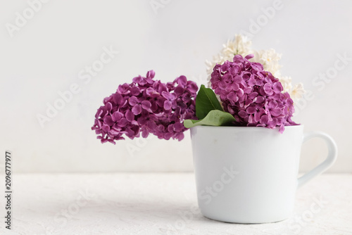 Cup with blooming lilac flo...