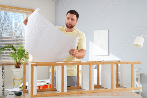 Young man with manual assem...