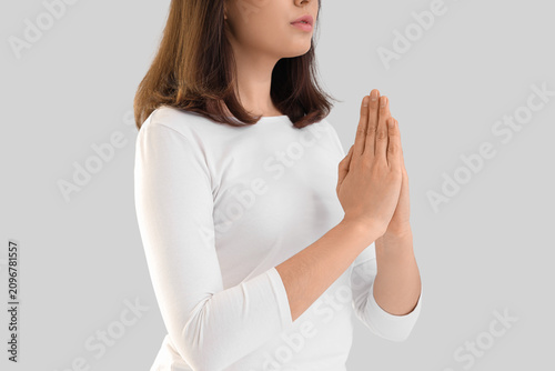 Young woman praying on ligh...