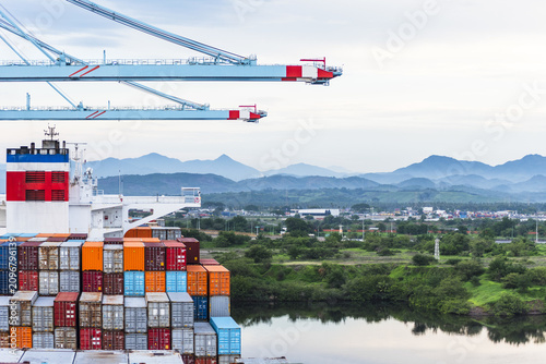 Container vessel undergoing port operations at container terminal in Lázaro Cárdenas, Mexico.
