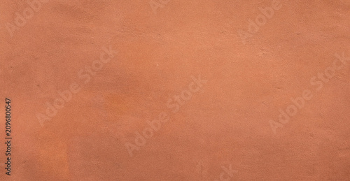 Fotografie A smooth texture of orange clay or terracotta, showcasing a warm earthy tone that adds depth and character to various design projects