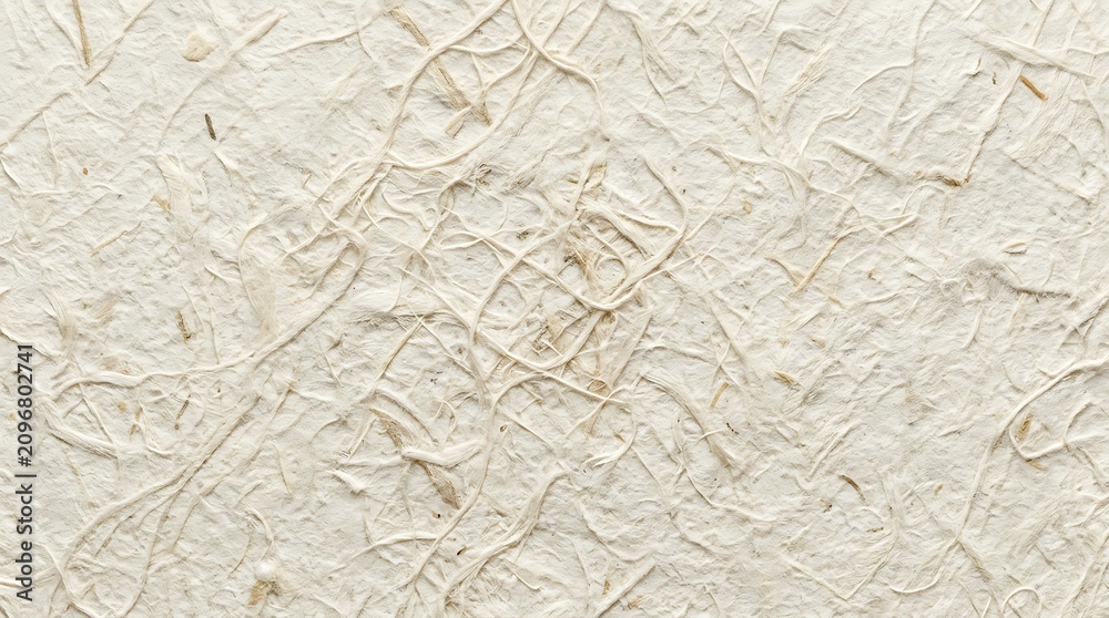Obraz premium Textured handmade paper background with visible fibers and natural tone