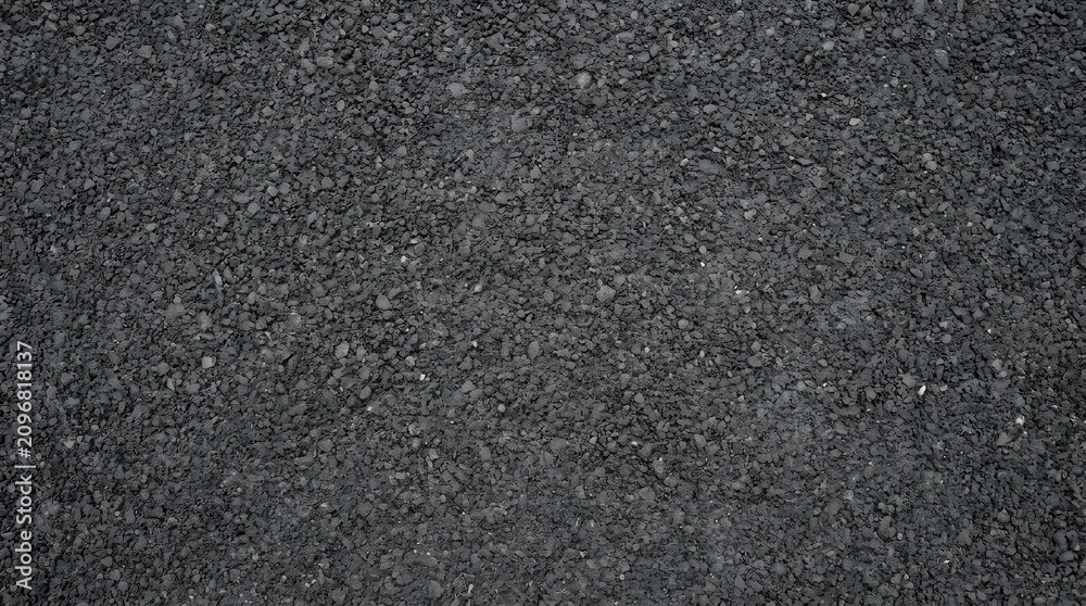Fototapeta premium Macro view of dark gray crushed stone asphalt texture surface.