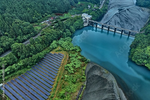 Aerial drone photo of solar panels and dam reservoir in Shiogou, Shizuoka, Japan