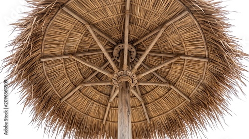Close-up view from below of a thatched roof umbrella, showcasing its intricate wooden structure and natural straw material