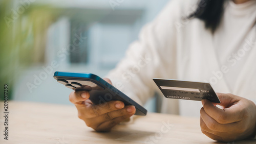 Fotografía Paying and shopping with credit card, mobile phone and computer for home busines