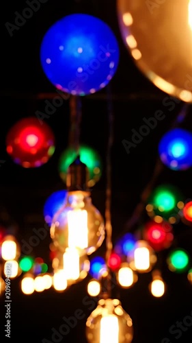 Warm Edison light bulbs with colorful bokeh background.