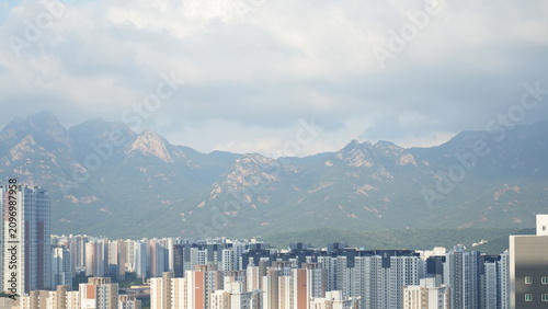High-rise apartment complex skyline with the majestic rocky peaks of Bukhansan mountain in the background, South Korea