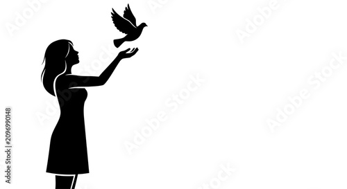 Billede på lærred Silhouette of a woman releasing a dove into the air representing peace and freedom