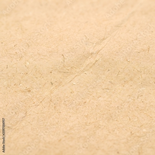 Close-up texture of natural beige linen fabric. Soft woven material background for design and fashion projects.