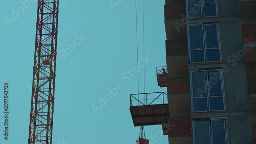 lifting bricks construction of new modern skyscraper or living building in city, real estate development 4k
