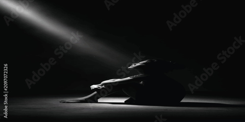 Canvastavla Lonely woman sitting on floor in dark room bathed in spotlight with spotlight da