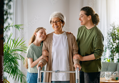 Happy Family Supporting Senior Woman with Walker at Home