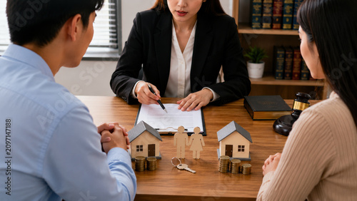 Mortgage contract home finance lawyer couple consultation signature meeting at office desk, miniature house, key, coin, gavel support confident decision for property purchase