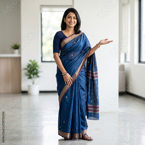 Indian businesswoman in saree presenting. Professional woman gesturing at copy space.