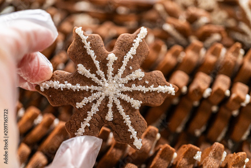 Snowflake Gingerbread Cookie Among Rows of Festive Holiday Treats
