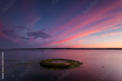 Cuadro en lienzo Calm lake at sunset with pink clouds