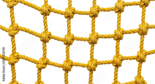 Fotografie Close-up view of a sturdy yellow rope net with secure knots against a white back