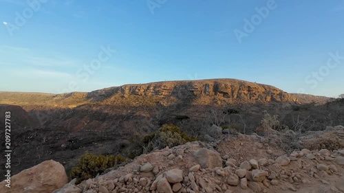 Dry rocky hillside beside a dirt road. Socotra, Yemen.