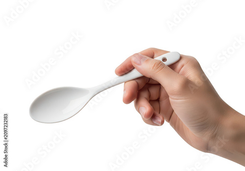 Hand holding a silver spoon
