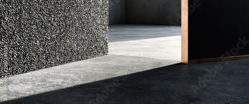 Textured dark wall contrasts with bright concrete floor and soft light