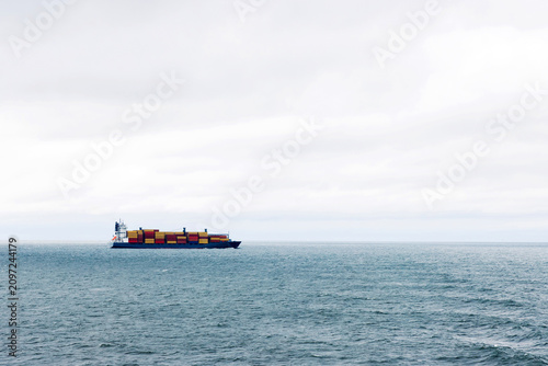 Container ship crossing Baltic sea between Helsinki and Tallinn. Minimal maritime landscape with copy space.