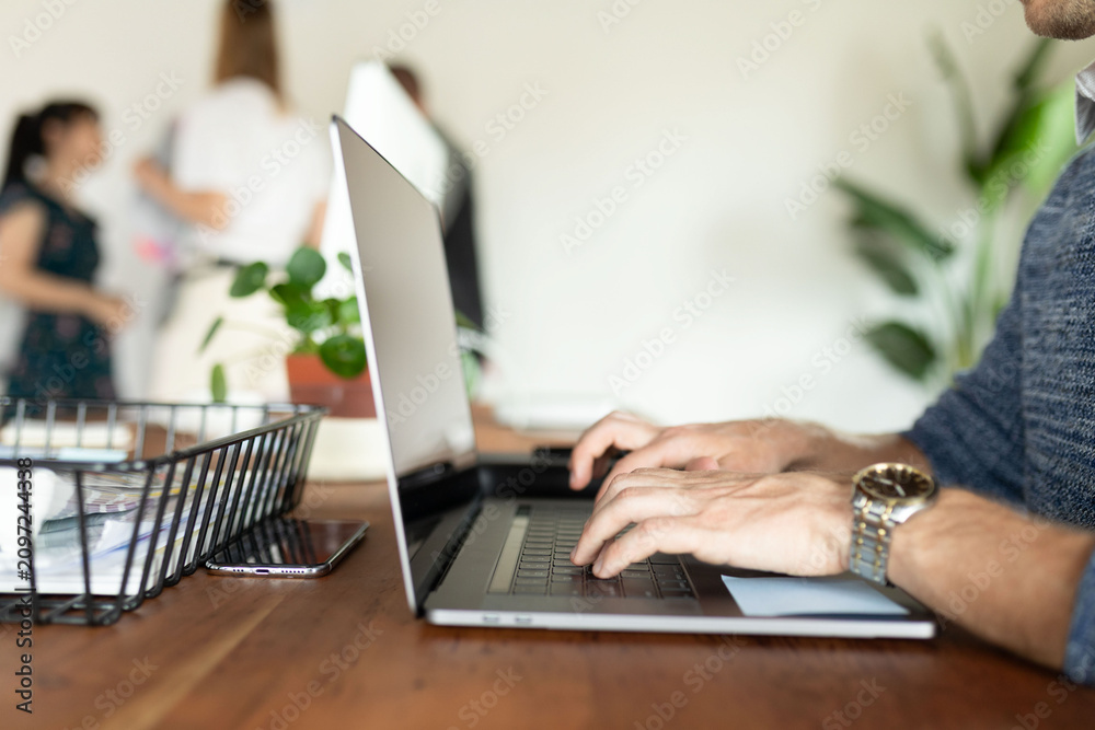Fototapeta premium Modern workspace with focused typing.