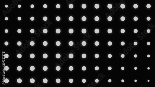 A grid of white circles diminishing in size on a deep black background