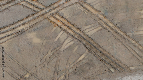 Aerial view wheel tire track on mud, Tire mark imprints on mud vehicles tires footprints transport ground trace or marks textures, wheel treads, Mud terrain.