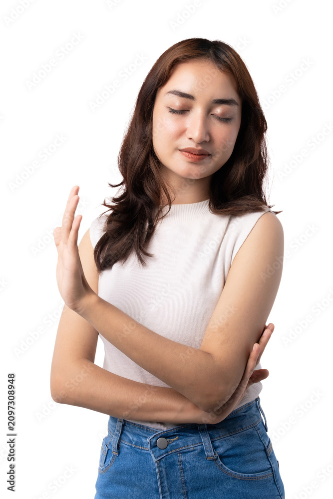 Fototapeta premium Calm young Asian woman refusing with eyes closed and raised palm on transparent background