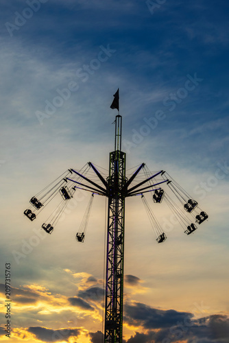 Silhouette of a high swing ride carousel at sunset amusement park in Sveti Vlas, Burgas, Bulgaria