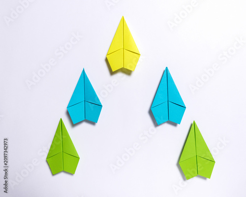 Yellow Paper Airplane Leading V Formation on White Background