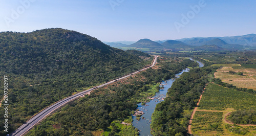 Quadro su tela Scenic drone photograph of Crocodile River in Mpumalanga, South Africa, revealing winding waterway, sunburnt grasslands, and dramatic valleys in golden morning light, 2026
