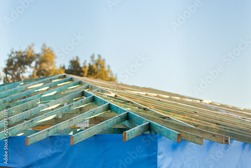wooden roof structure of house under construction during housing crisis