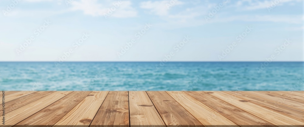 Fototapeta premium Wooden Table Overlooking Calm Sea Under Clear Blue Sky