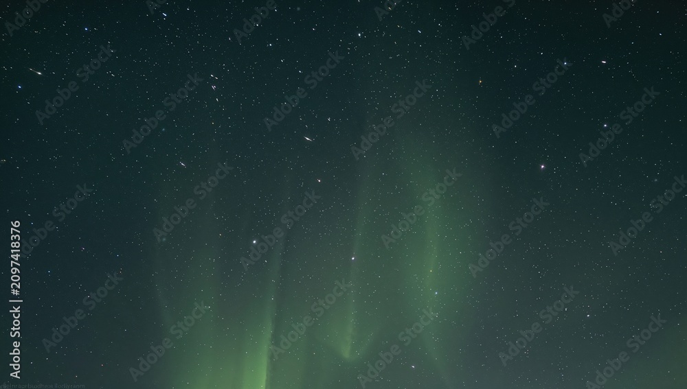 Fototapeta premium Northern Lights Displaying Over a Starry Sky at Night