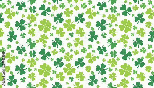 Seamless St. Patrick's Day pattern featuring scattered green three and four leaf clovers on a white background.