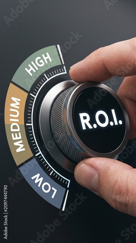 A macro shot of a hand adjusting a metallic control dial with low, medium high scale segments, technical business analytics and ROI measurement
