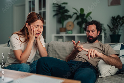 Quadro su tela Couple having serious conversation at home, discussing relationship problems and