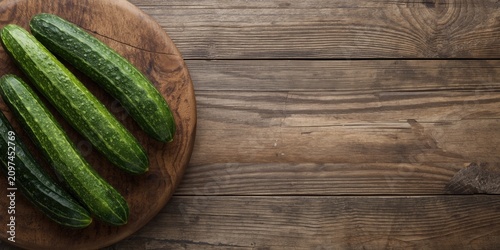 Fresh Cucumbers on Wooden C...