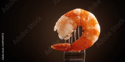 Plump shrimp on fork agains...