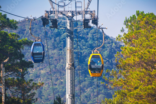 Cable car ropeway cabins in cableway above forest in the mountains in Dalat city in Vietnam in Asia