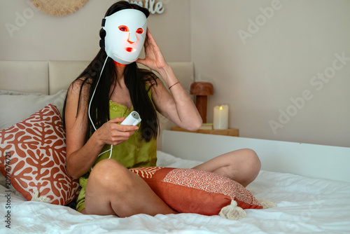 Woman using Led Red Light Facial Mask Treatment